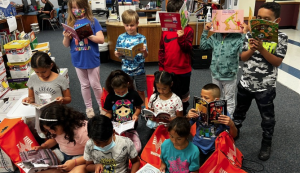 kids with gift books in a school